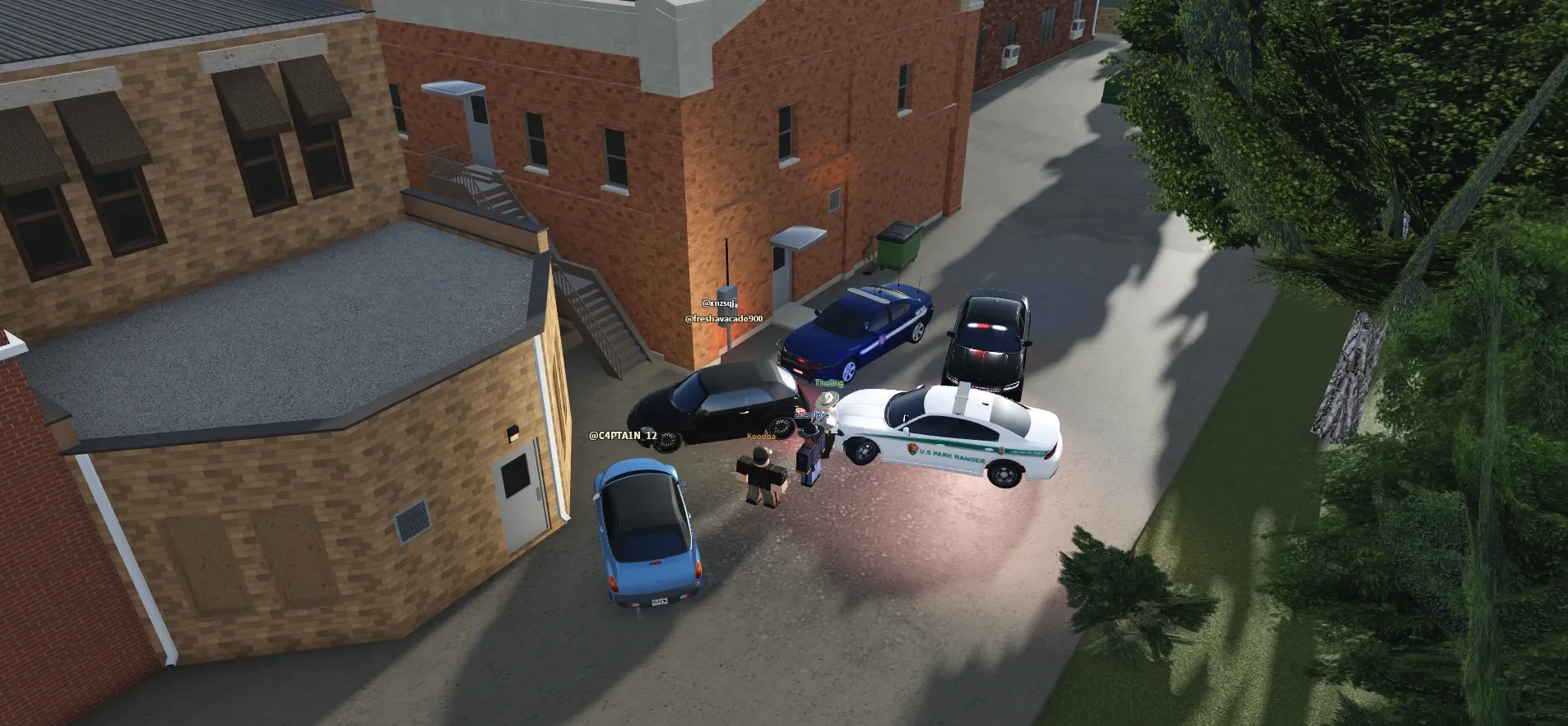 An aerial view of players and their cars gathered in a brick alley in Greenville.