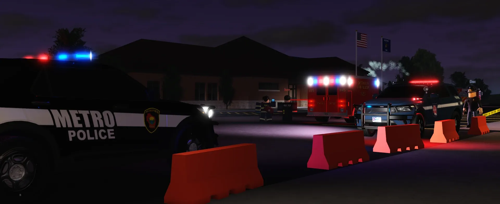 A Metro Police SUV and a GVFD ambulance with lights on at a night scene, behind orange barricades.
